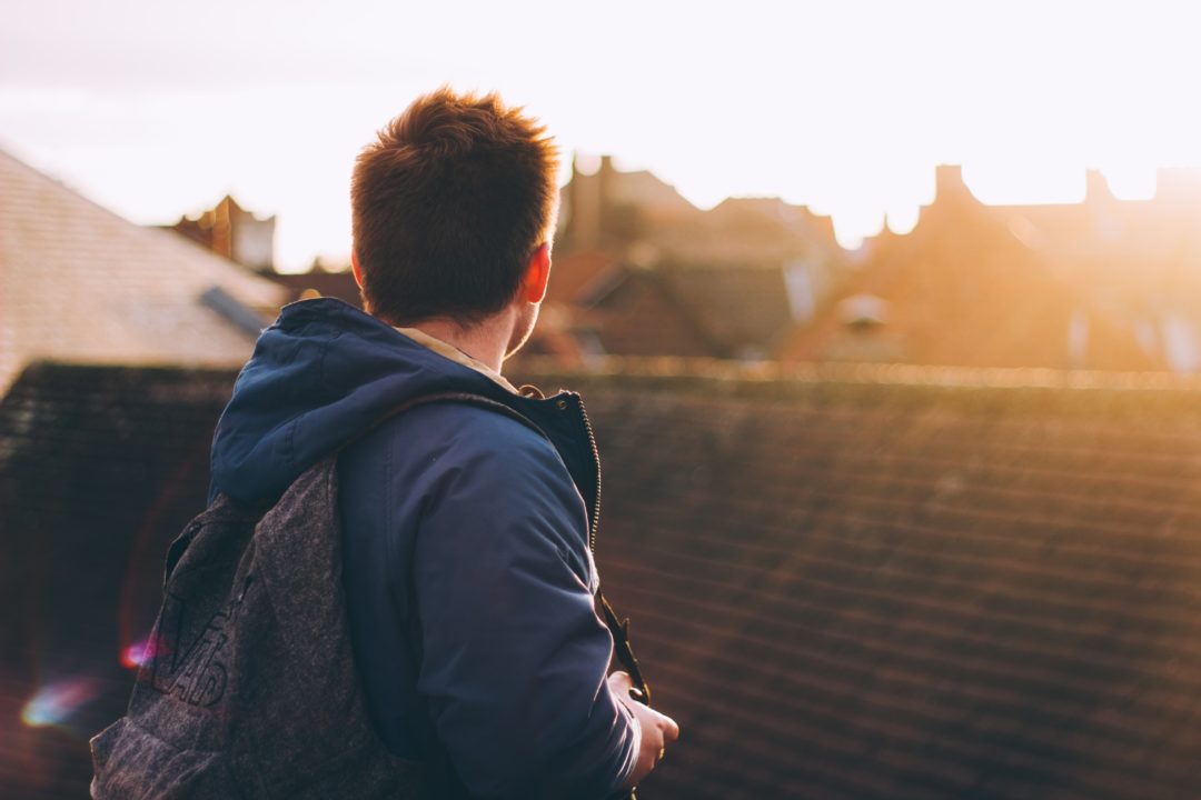 man looking at sunrise