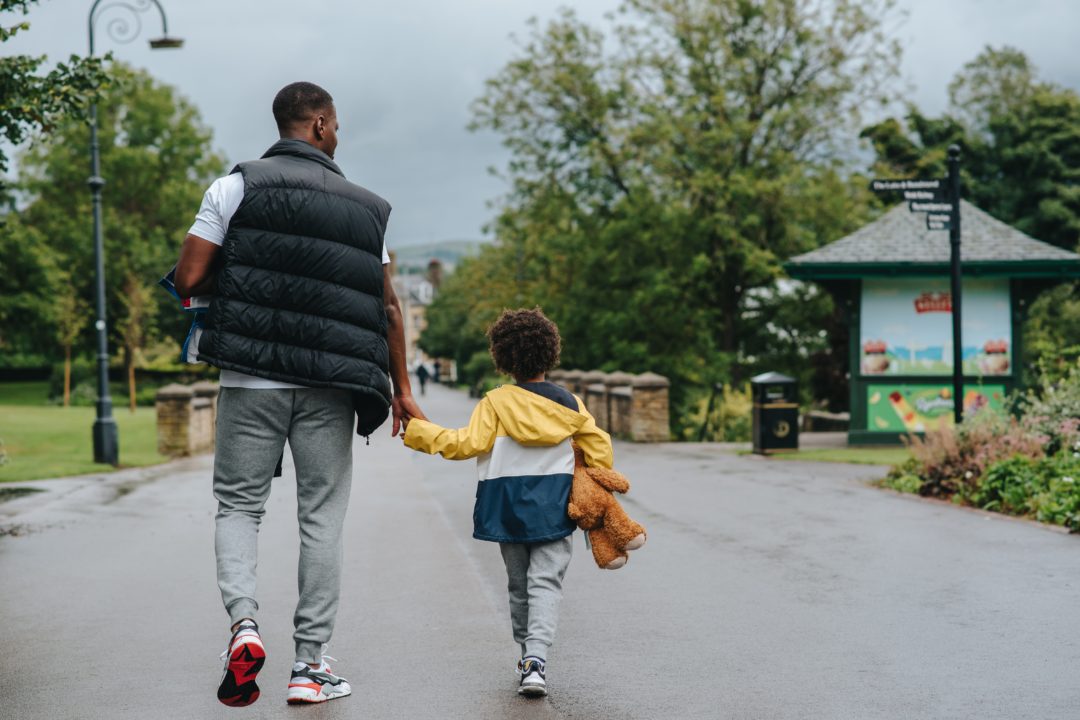 Father and son walking holding hands