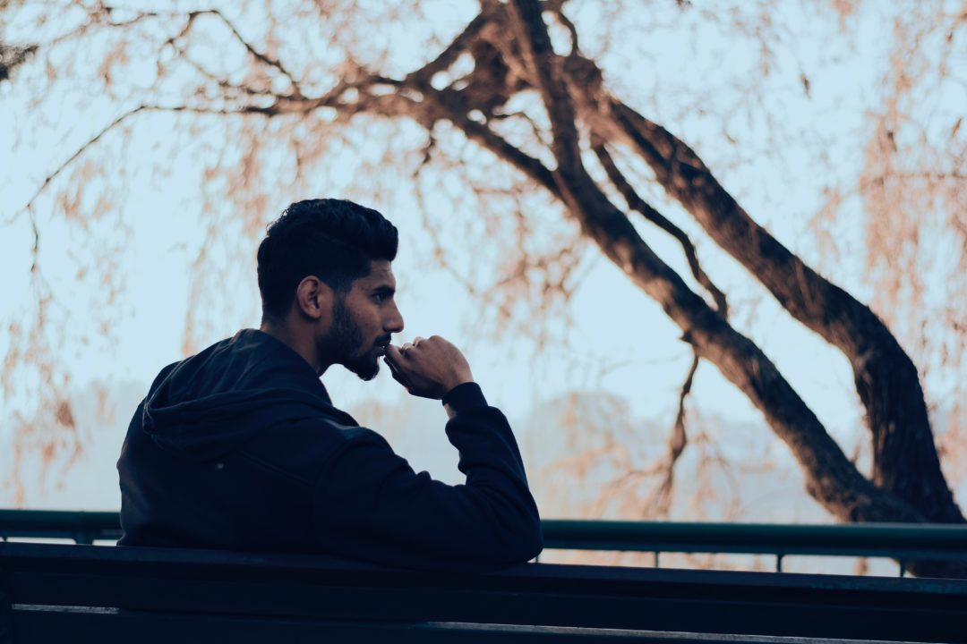 Man thinking on a bench