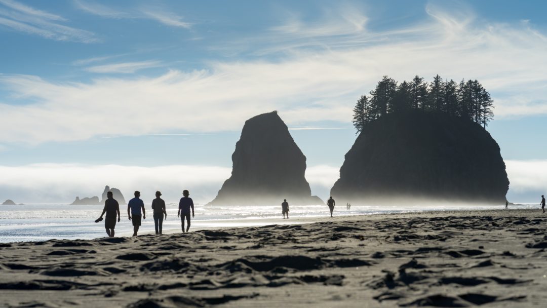 family walking together on the beach