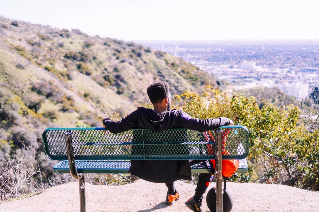 Man sitting on a bench on a hike