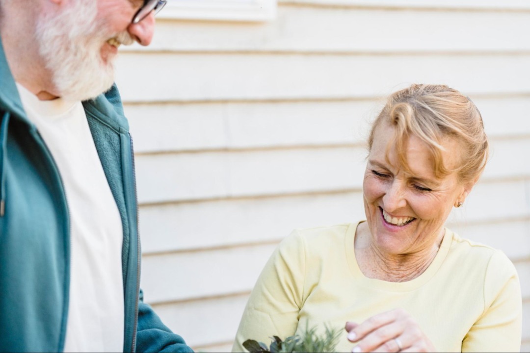 Elderly couple gardening together