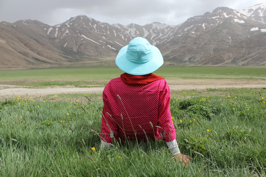 Person sitting looking at the mountains