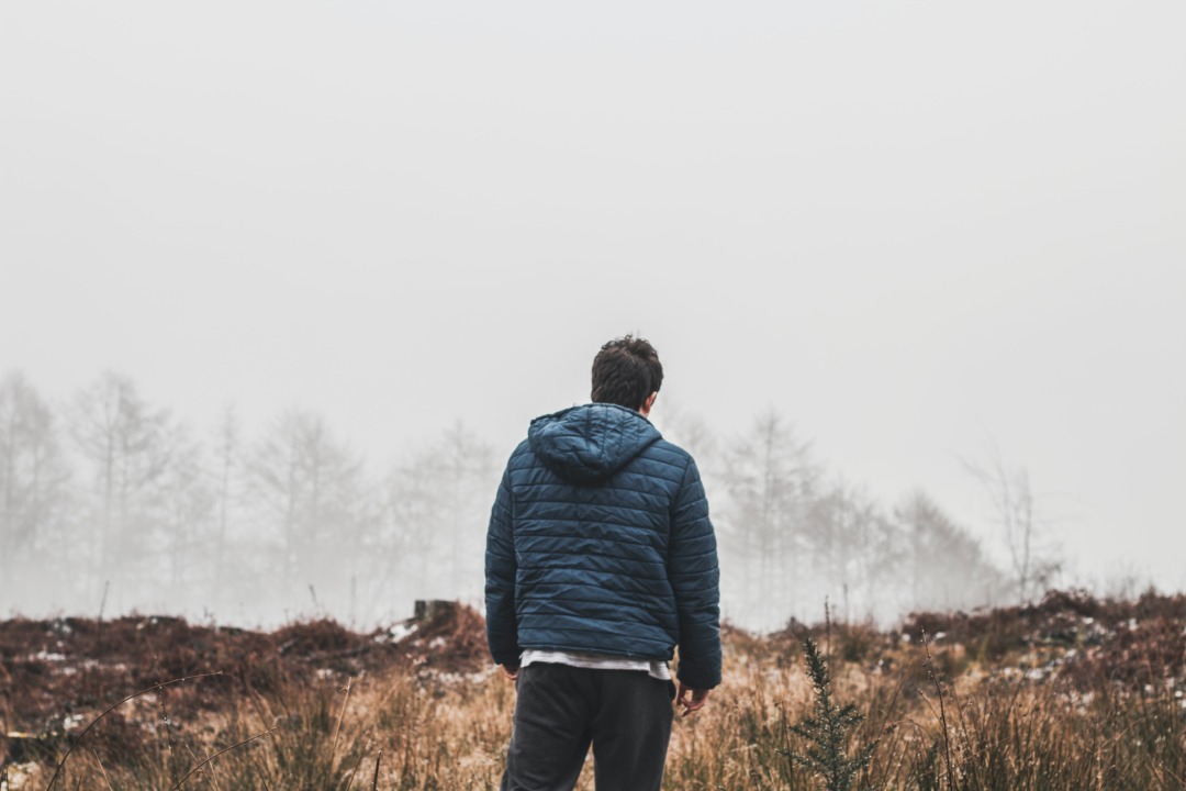 man looking out at mountains