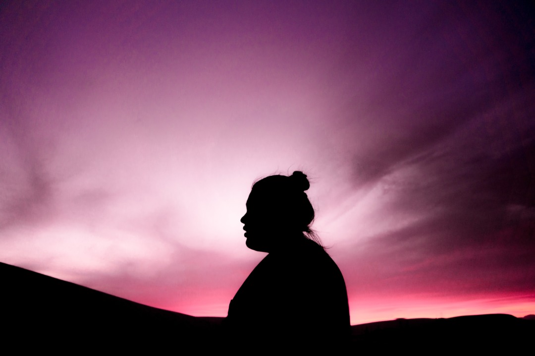 person with purple sunset