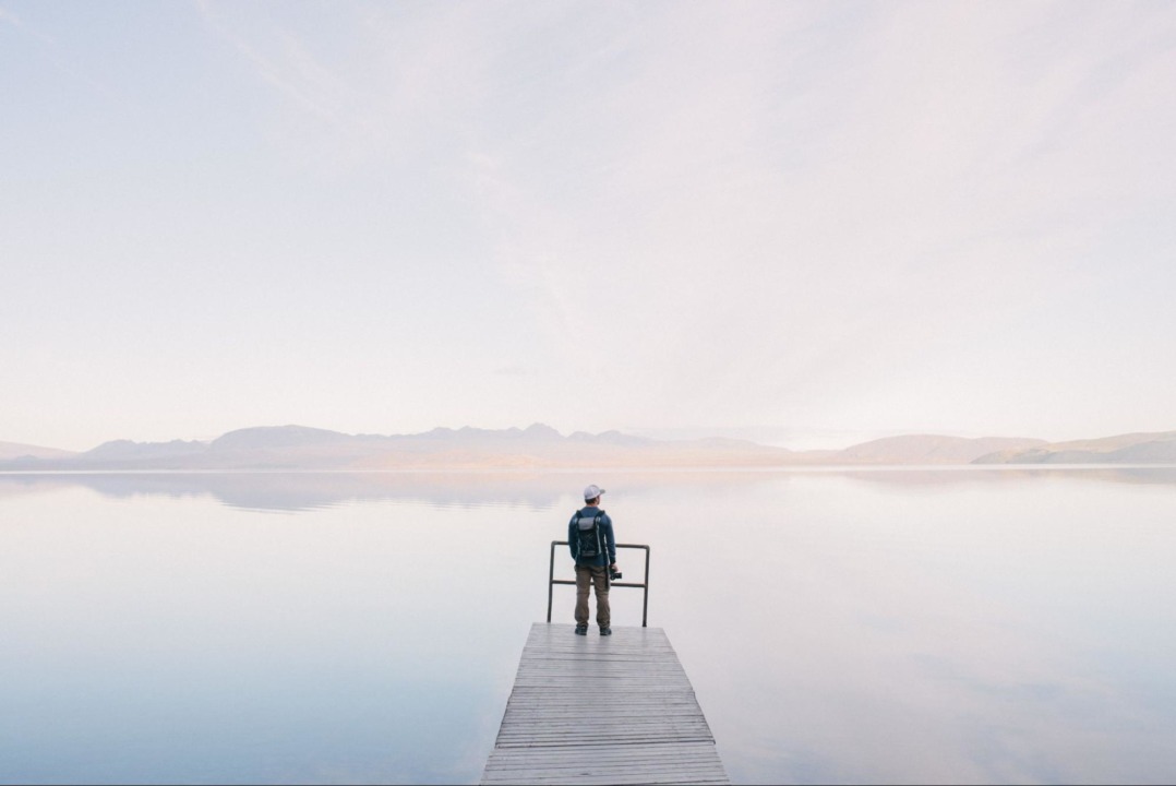 person looking at lake in the morning