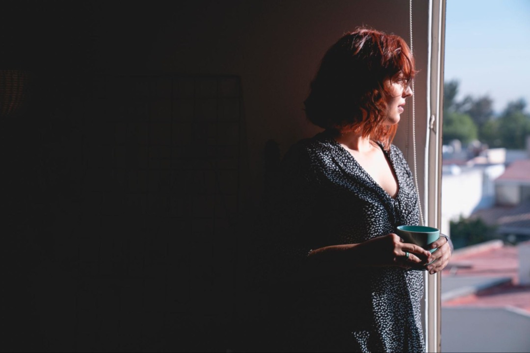 Woman looking out window