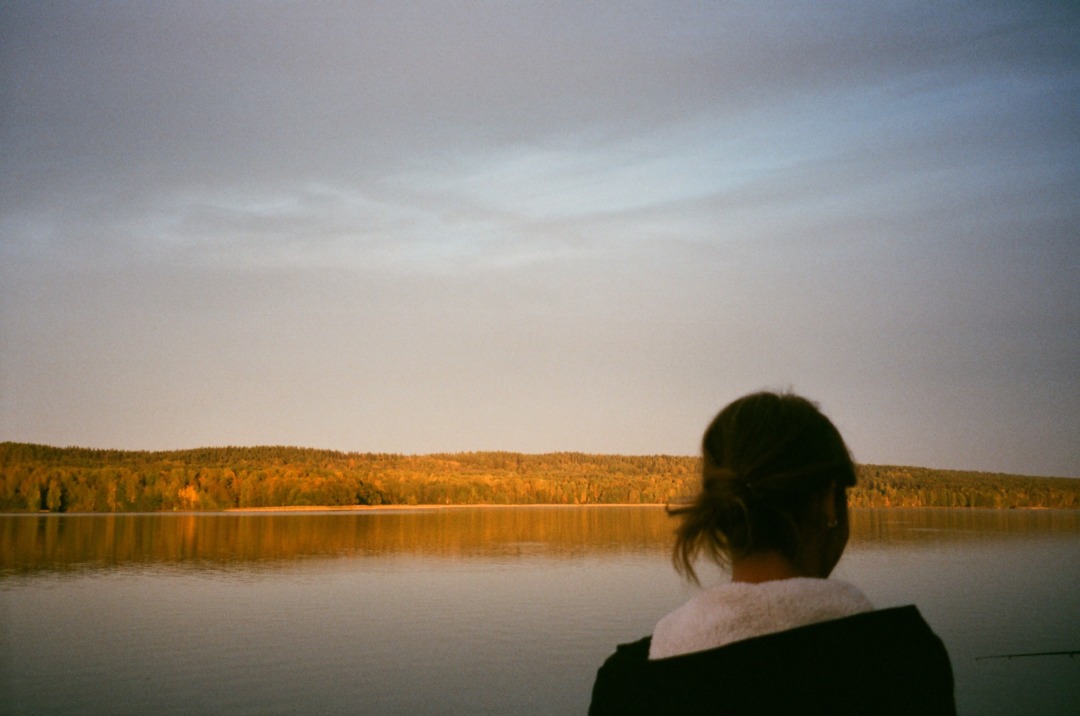 Person looking out at lake in the evening