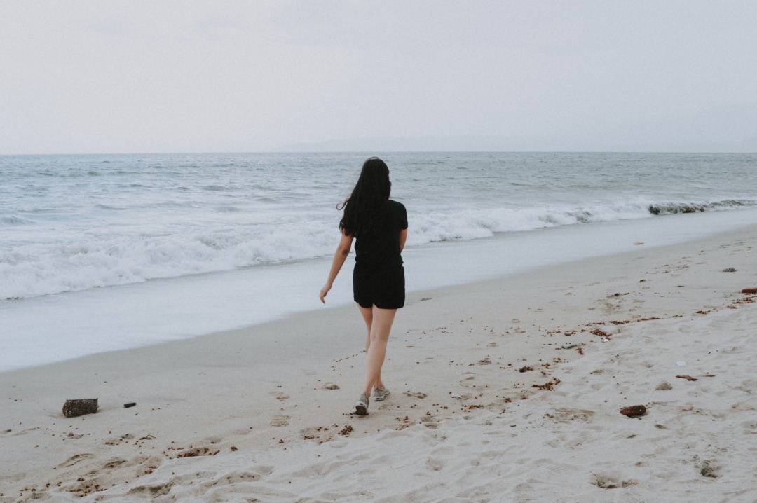 Person walking alone on beach