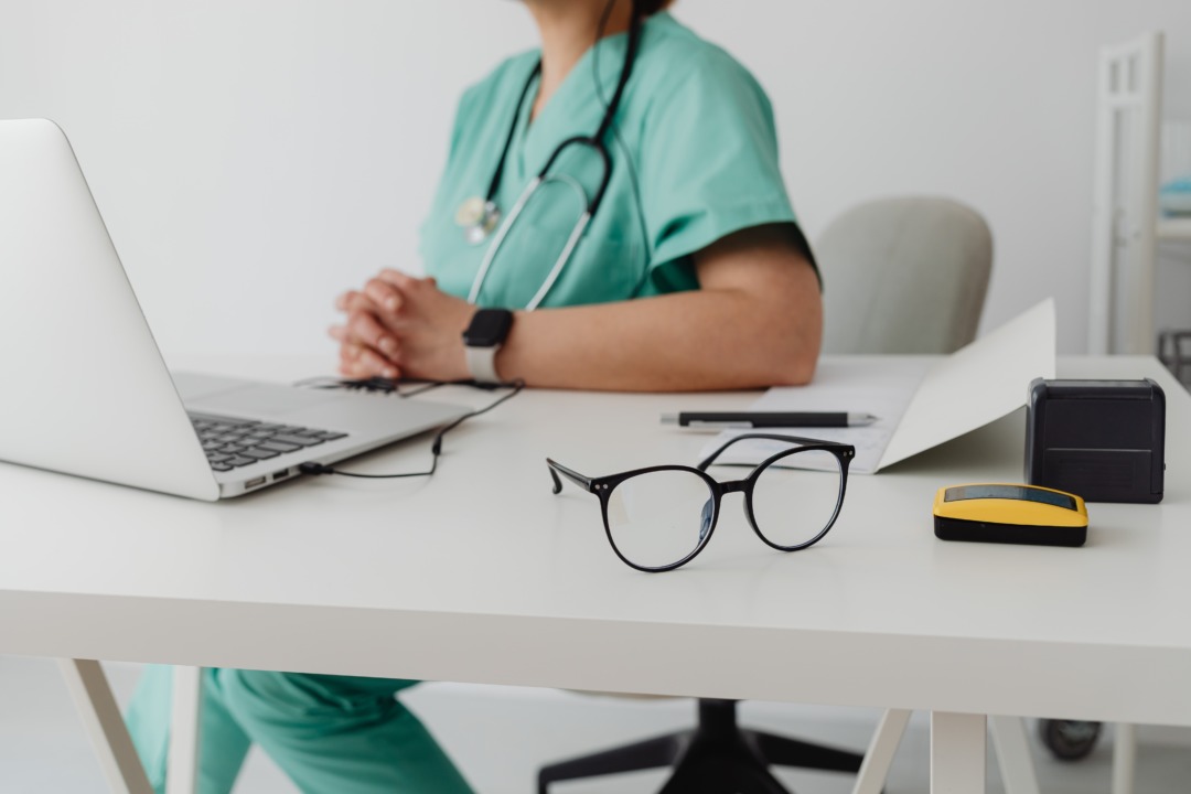 Doctor on computer at desk