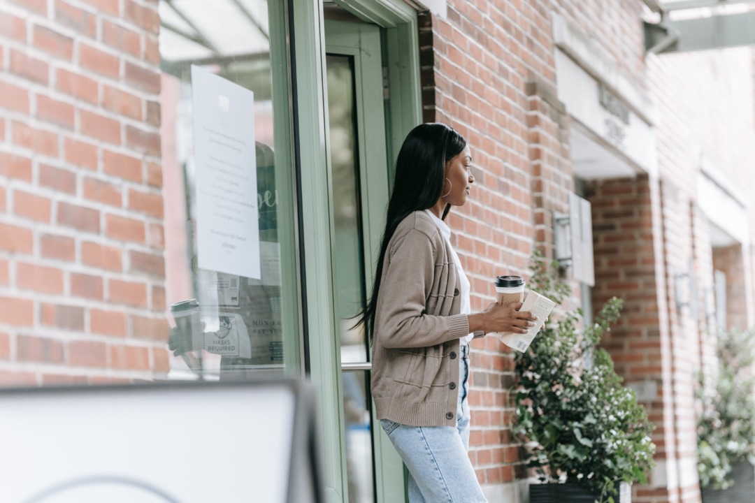 woman exiting coffee shop