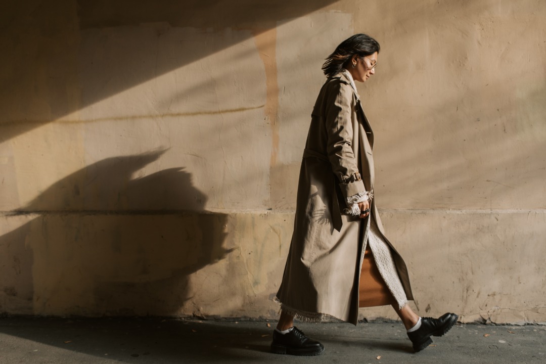 woman walking in a long coat