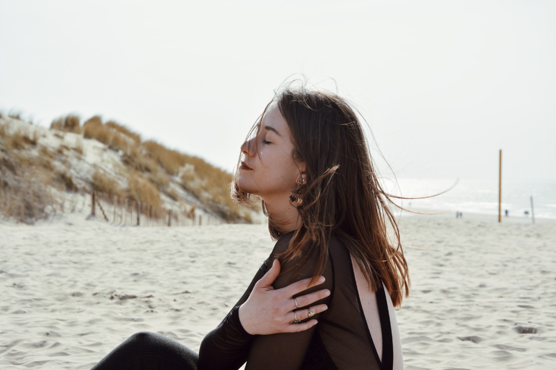 Girl hugging herself on the beach