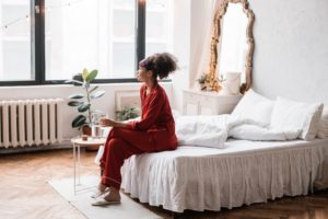 woman sitting on bed