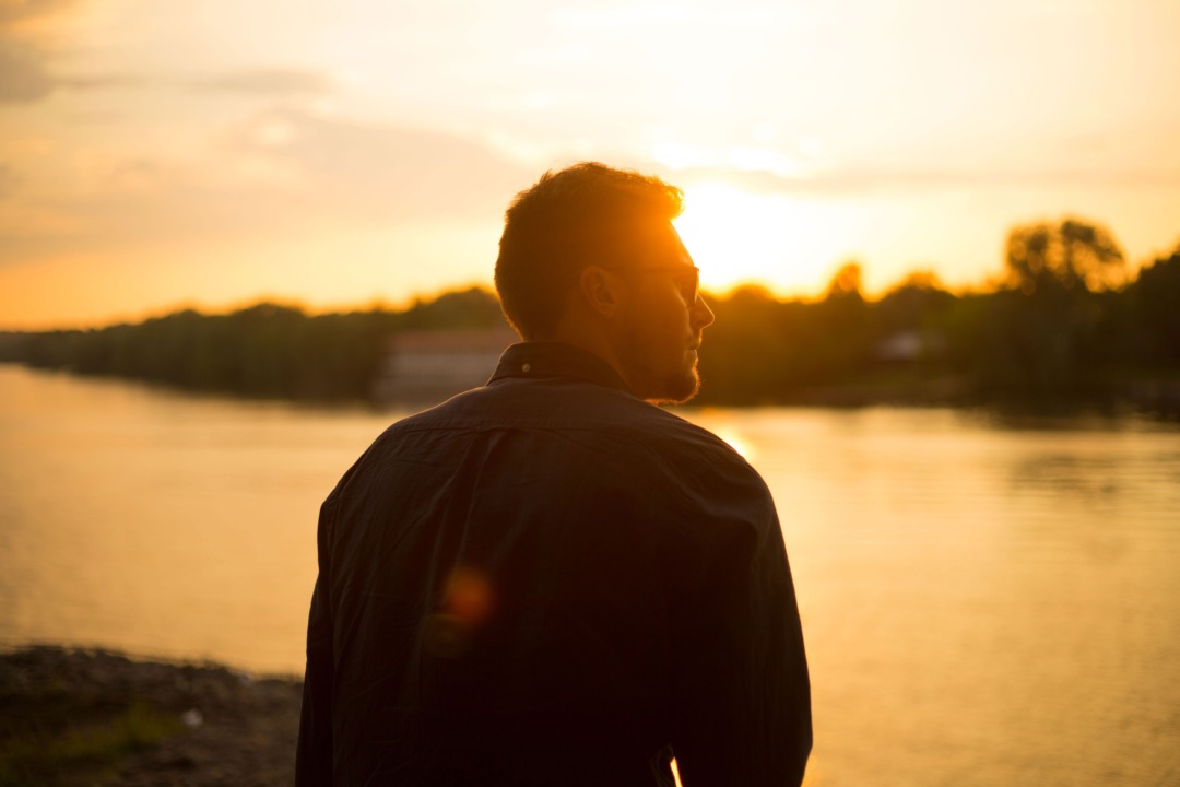 man at sunset lake