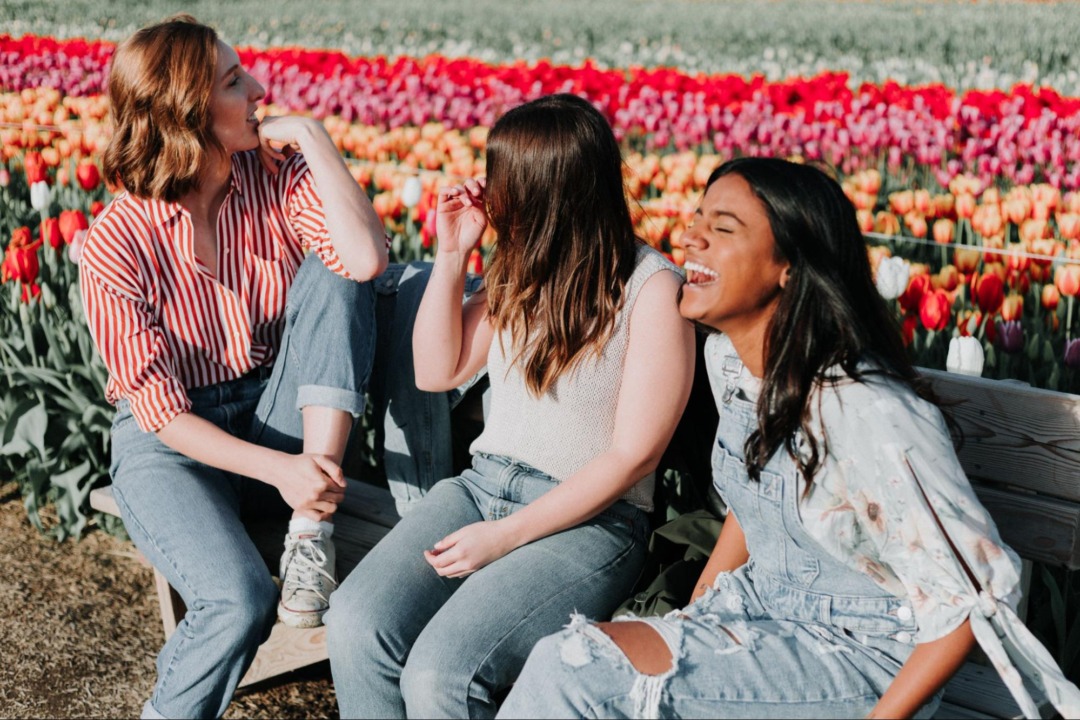 Group of friends laughing in a flower patch
