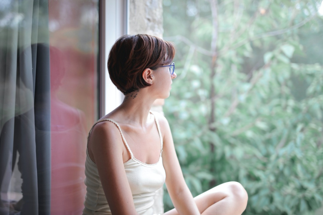 Woman looking out a window