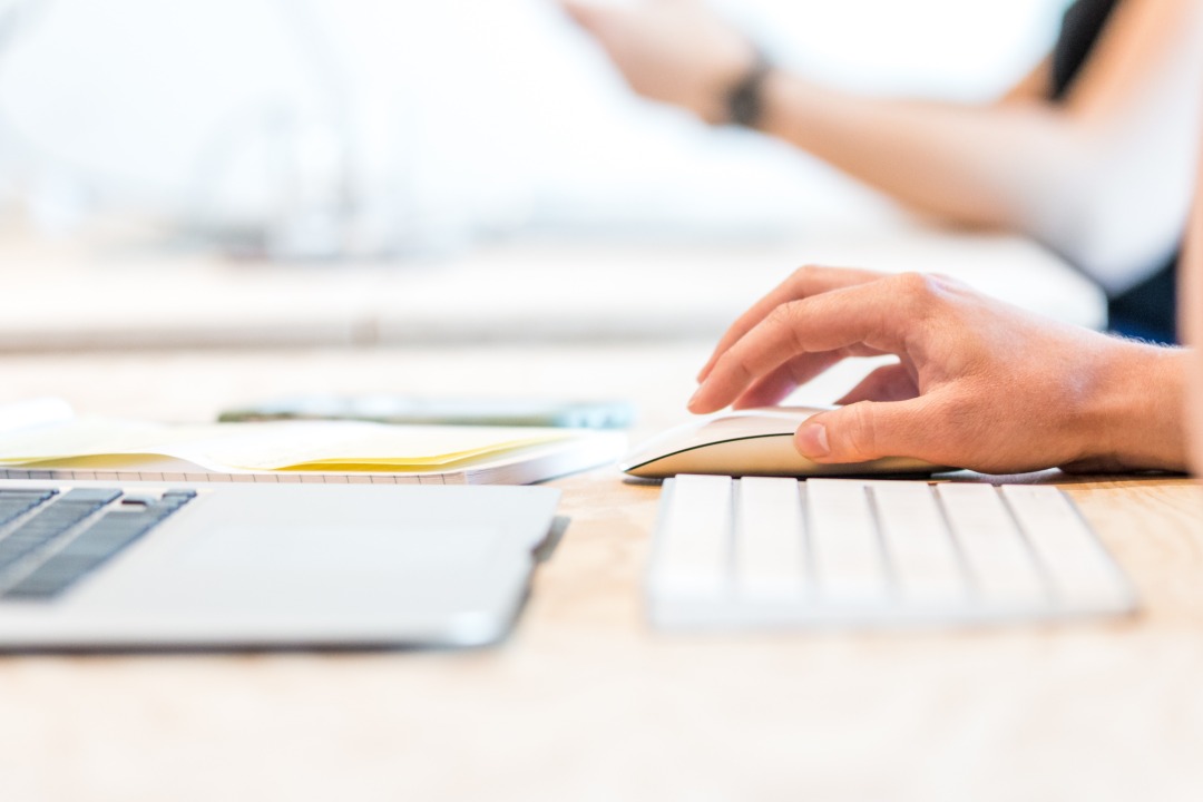 desk with person on computer